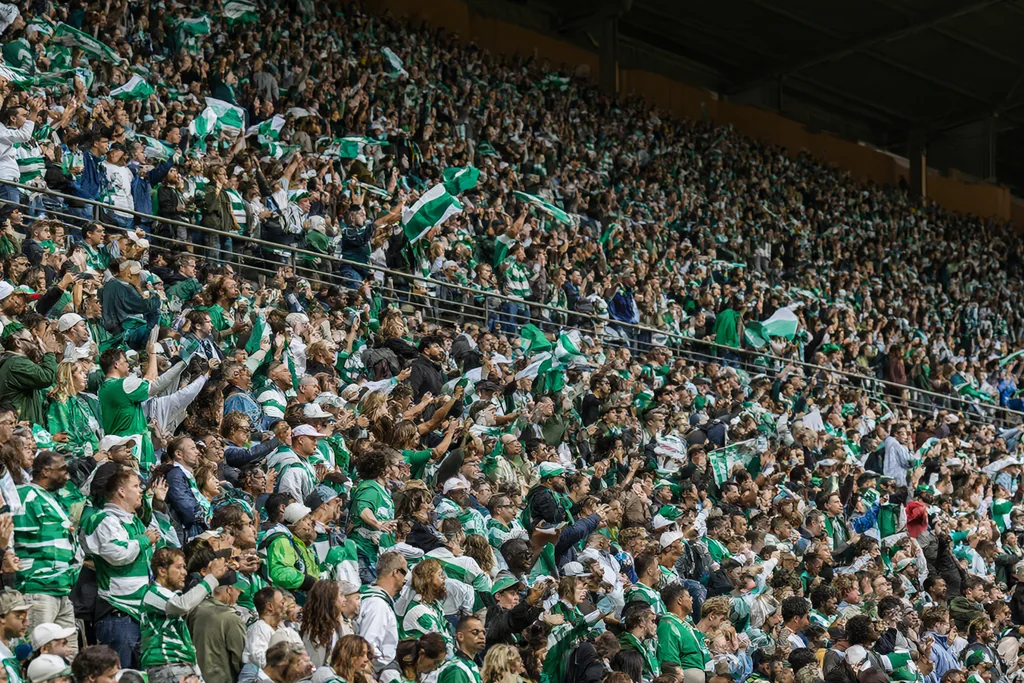 Tiered seating and a roof line at a large Spanish football stadium in daylight